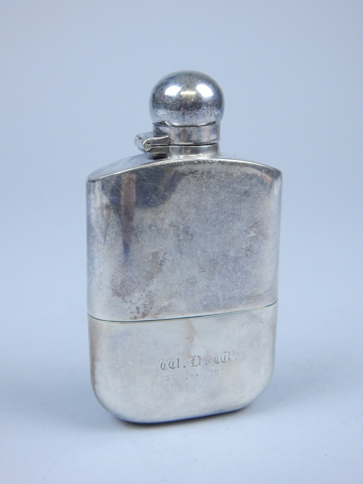 Appraisal: A hip flask silver plated with detachable silver base Sheffield