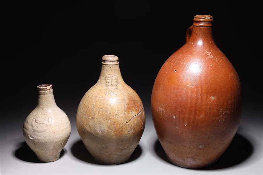 Appraisal: Group of three antique German bellarmine jugs th century or