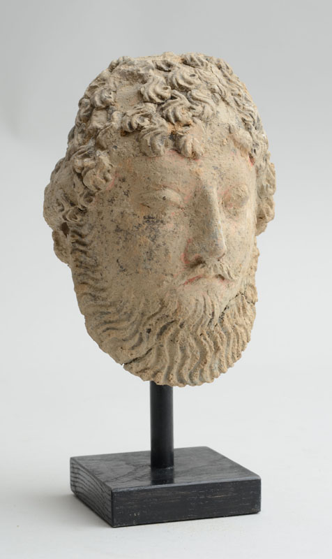 Appraisal: GANDHARAN POLYCHROME CLAY HEAD OF A PERSIAN DIGNITARY Possibly th-