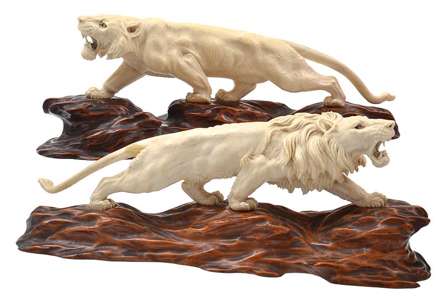 Appraisal: A JAPANESE IVORY LION AND JUVENILE LION ON STAND LATE