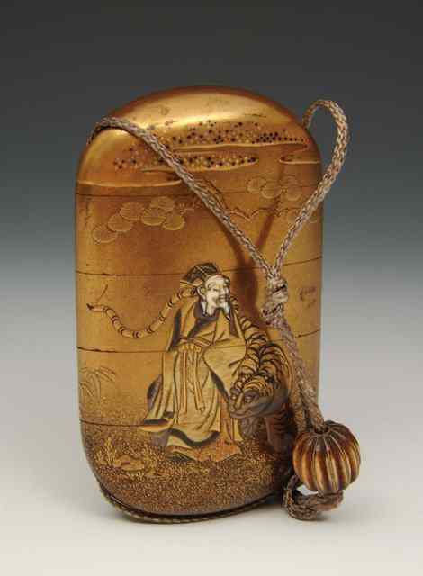 Appraisal: A JAPANESE GOLD LACQUER INRO decorated a figure with tiger