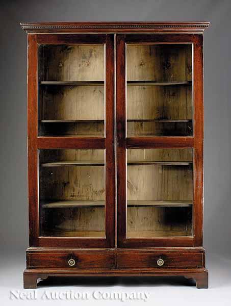 Appraisal: A Georgian-Style Mahogany Bookcase c the later dentil molded cornice