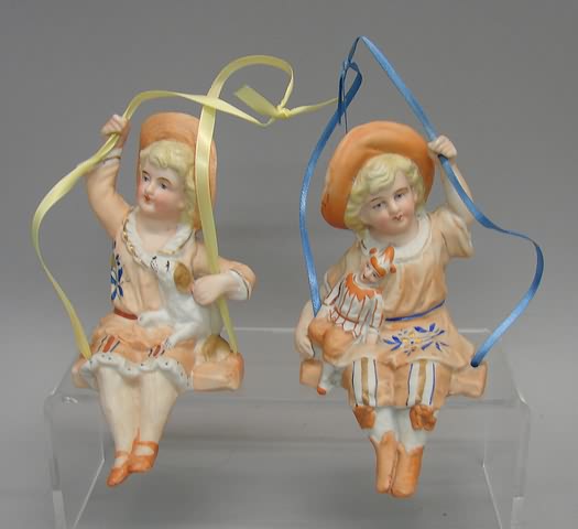 Appraisal: -Bisque Swing figurines-boy w dog girl w doll Pair of