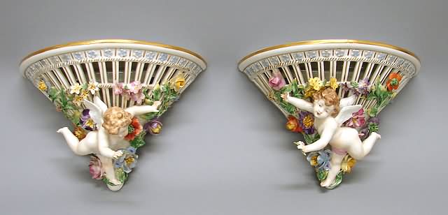 Appraisal: Each of reticulated half-cone shape with putto and painted applied