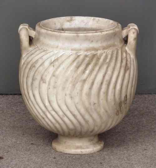 Appraisal: A heavy white marble two-handled urn of classical form with