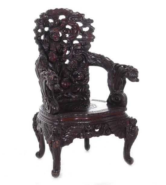 Appraisal: Chinese carved hardwood armchair early th century elaborately carved figural