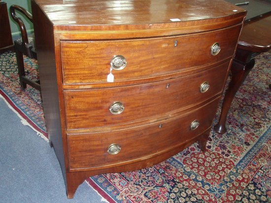 Appraisal: An early th Century mahogany bowfront chest of three long