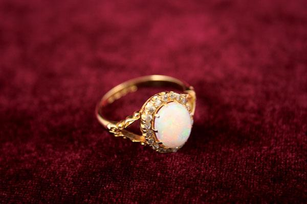 Appraisal: An Opal and Diamond Ring ct gold claw-set with a