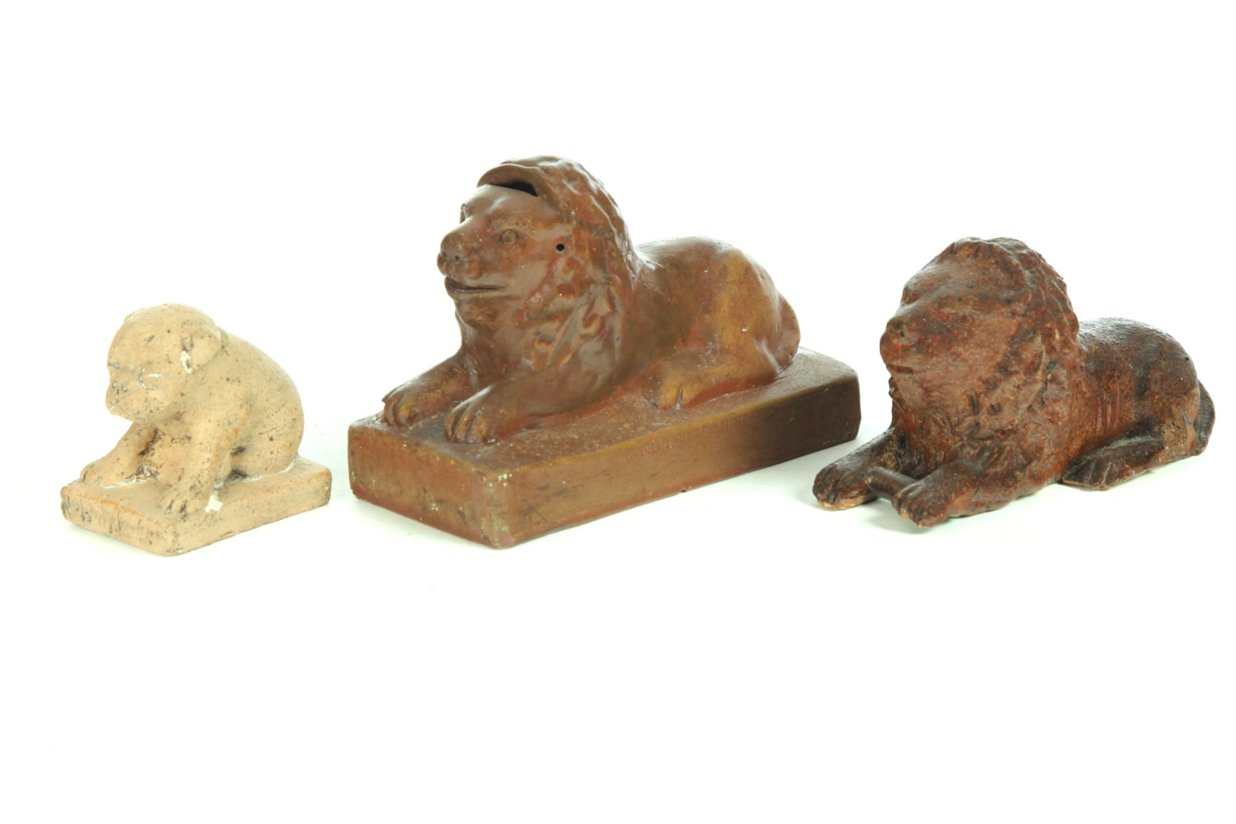 Appraisal: TWO POTTERY LIONS AND A DOG American early th century