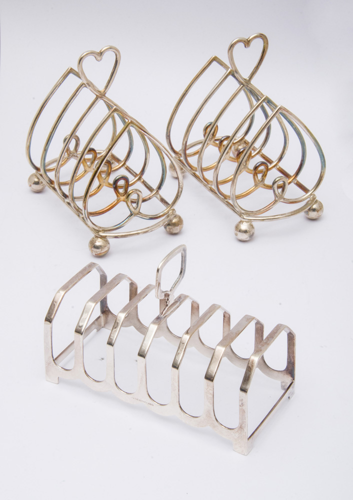 Appraisal: PAIR OF ENGLISH SILVER BREAKFAST FOUR-PIECE TOAST RACKS AND A