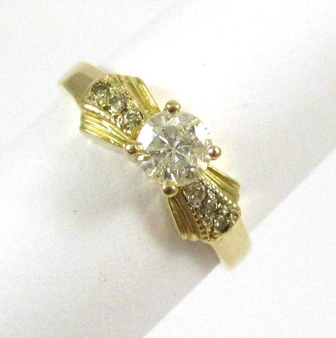 Appraisal: DIAMOND AND FOURTEEN KARAT GOLD RING with three round-cut diamonds