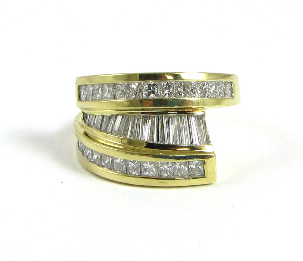 Appraisal: DIAMOND AND EIGHTEEN KARAT GOLD RING channel set with two