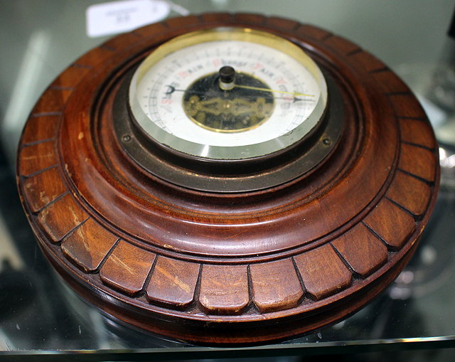 Appraisal: A HARDWOOD CASED CIRCULAR ANEROID BAROMETER with ring suspension to