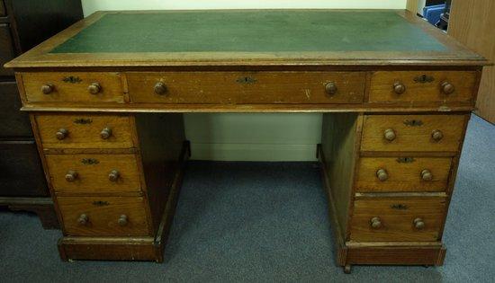 Appraisal: An pine kneehole desk fitted a surround of nine drawers