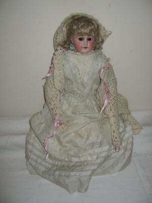 Appraisal: An Armand Marseille bisque shoulder head girl doll with brown