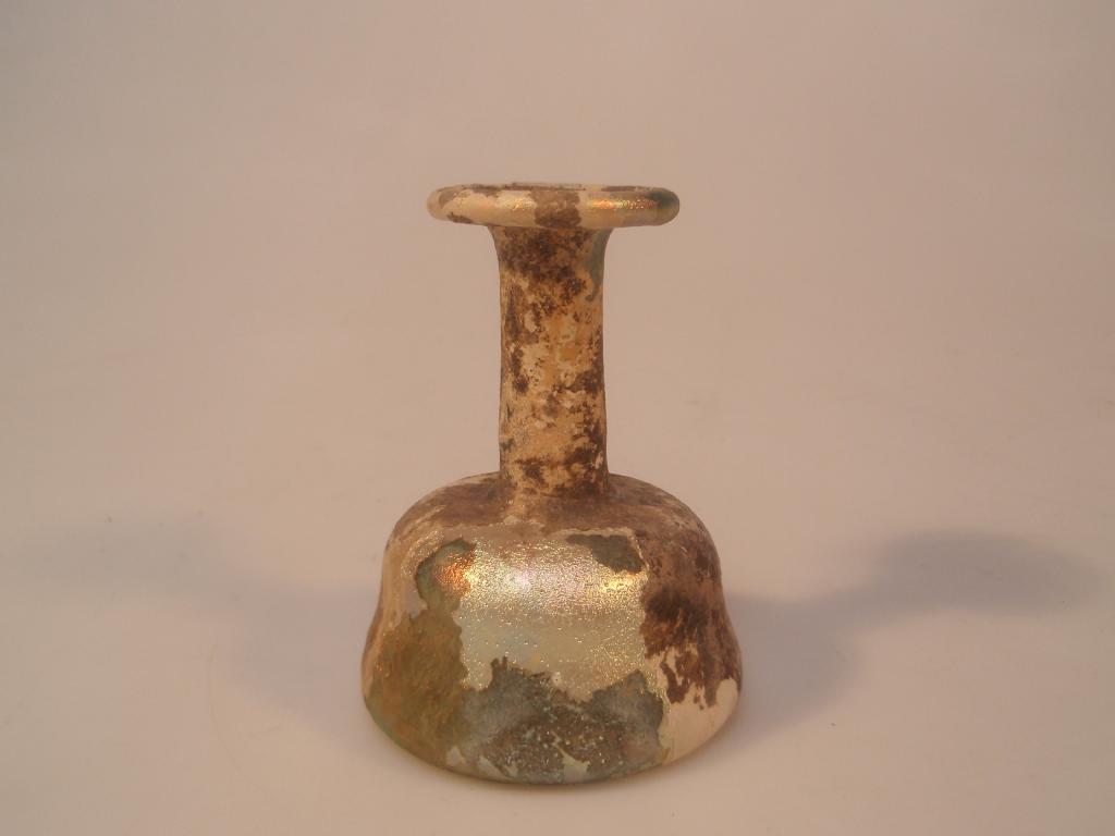 Appraisal: A Roman light bluish-green glass 'candlestick' unguentarium the everted mouth