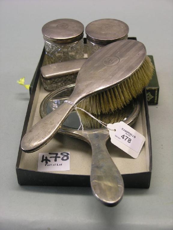 Appraisal: A silver four piece dressing set consisting of hairbrush hand