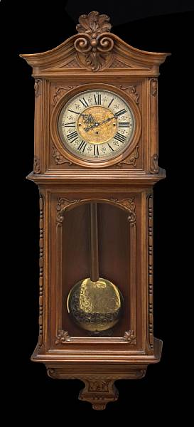 Appraisal: A Continental carved walnut quarter chiming wall clock fourth quarter