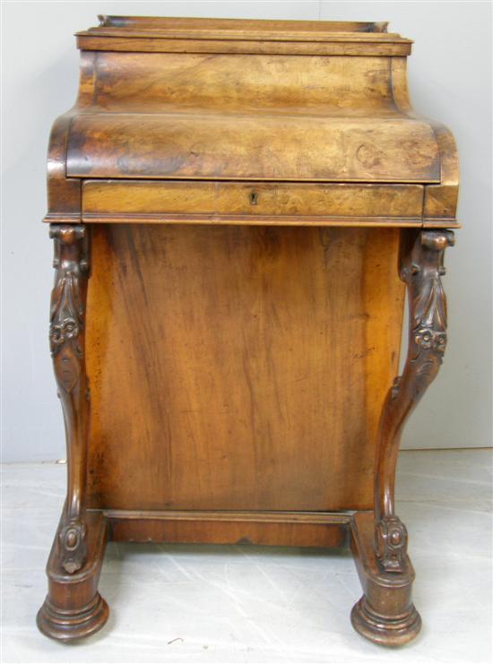 Appraisal: Victorian walnut Davenport with hidden drawers and pigeon holes in