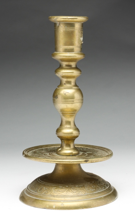 Appraisal: CONTINENTAL BRASS CANDLESTICK Eighteenth century Baluster stem and a mid