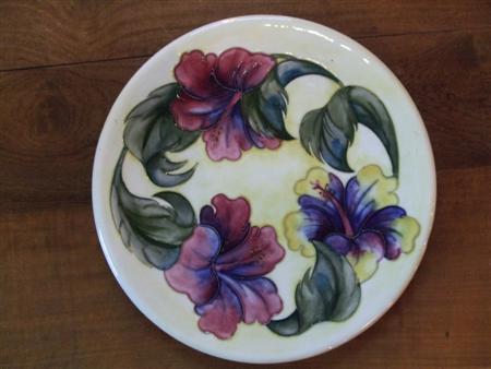 Appraisal: MOORCROFT POTTERY TWO CIRCULAR CHARGERS S one decorated with hibiscus