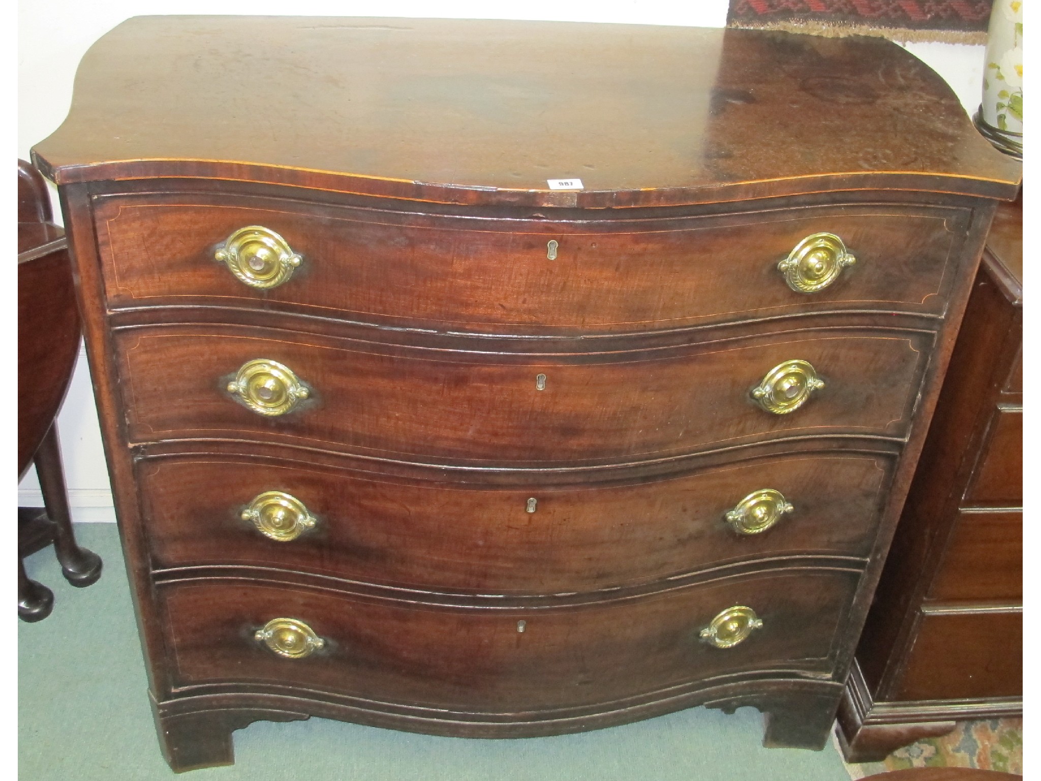 Appraisal: A th Century mahogany serpentine four drawer chest with serpentine