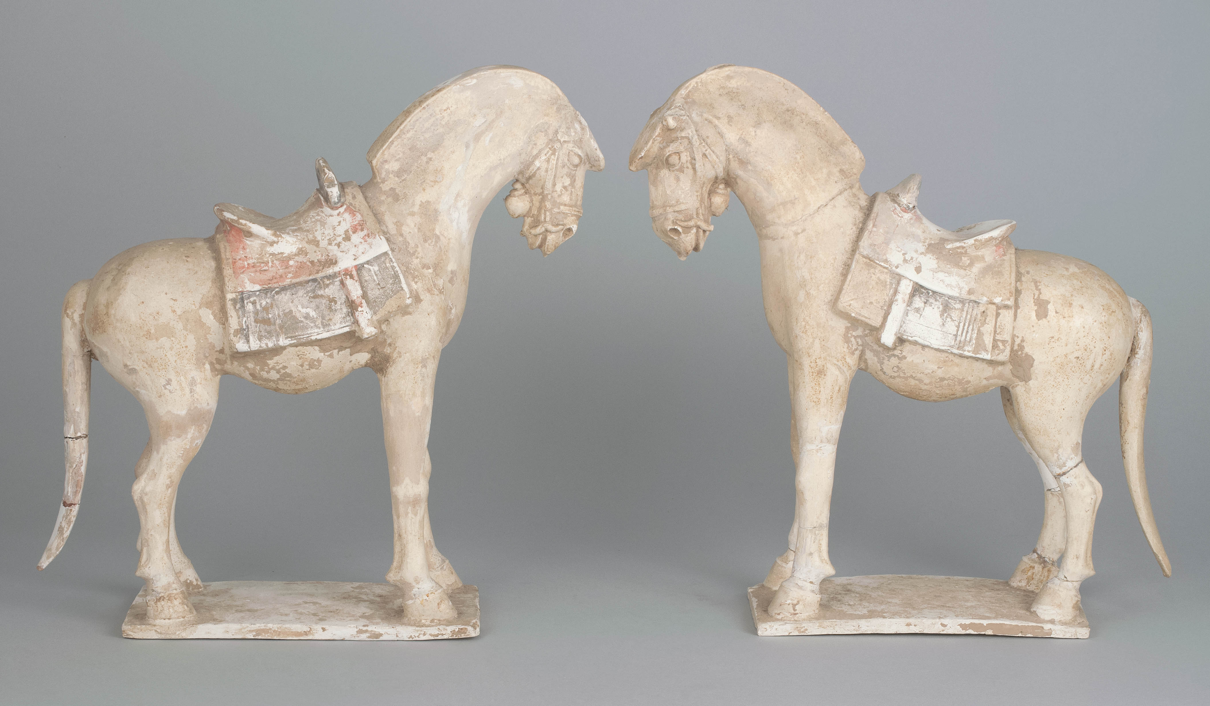 Appraisal: PAIR OF POTTERY HORSE FIGURES Late Tang DynastyEach saddled and