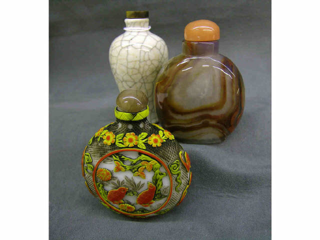 Appraisal: Three antique oriental snuff bottles including one agate one carved