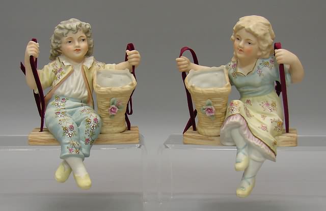 Appraisal: Pair of bisque Swing figurines Boy and girl each sitting