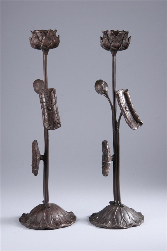 Appraisal: PAIR PATINATED METAL CANDLESTICKS th century Modelled in the Japonaiserie