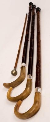 Appraisal: Three walking sticks with horn handles and silver collars all