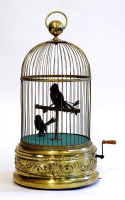 Appraisal: A SINGING BIRD AUTOMATON with two feathered birds one standing