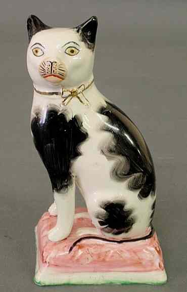 Appraisal: Staffordshire black and white cat th c seated on a