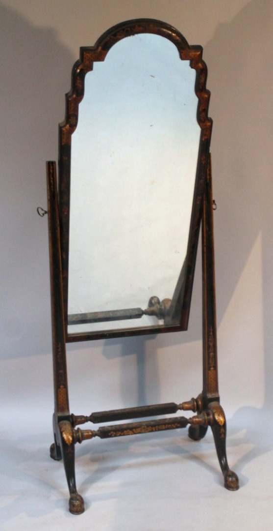 Appraisal: A Japanned ebonised cheval mirror with a shaped outline flanked