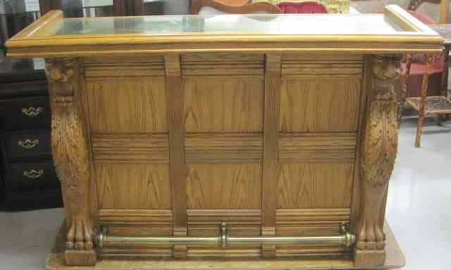 Appraisal: CARVED AND PANELED OAK FRONT BAR American antique reproduction having