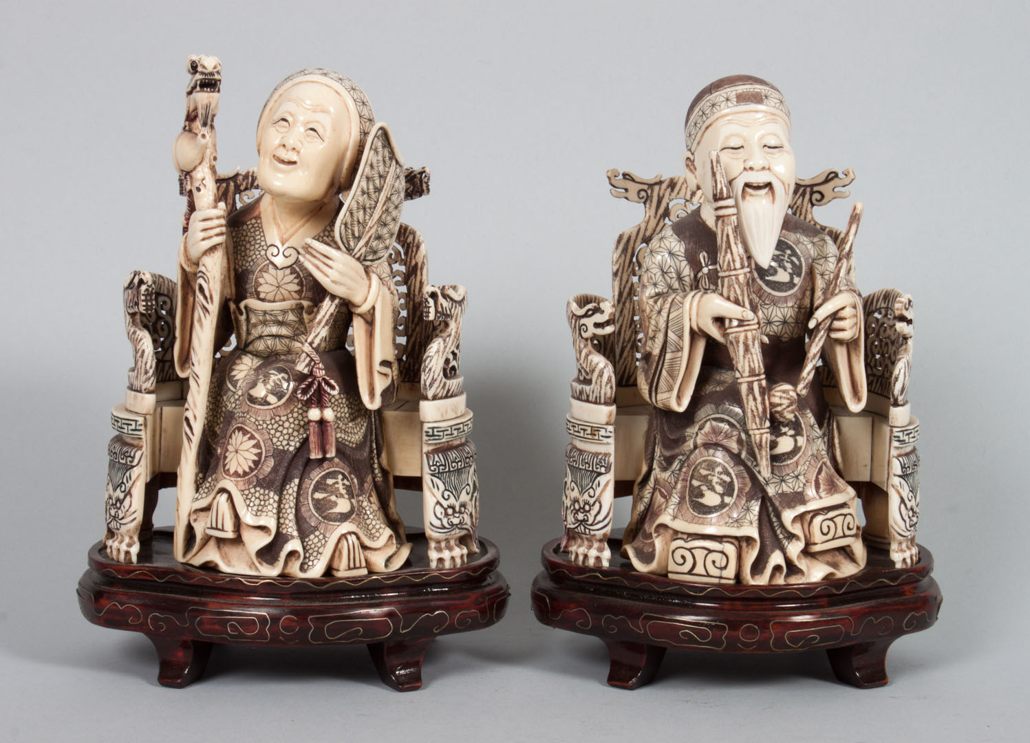 Appraisal: Pair of Chinese carved ivory elders modeled as elderly mandarin