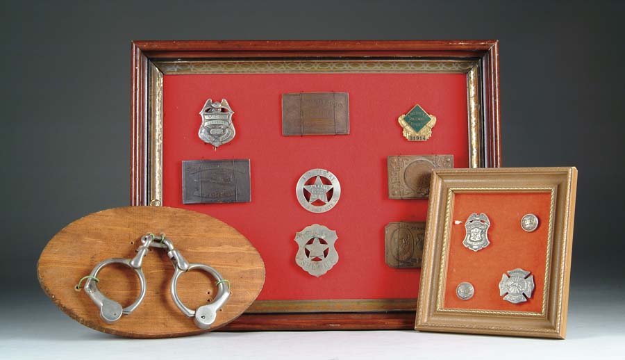 Appraisal: LOT OF THREE FRAMES OF BADGES BUCKLES HAND CUFFS Large