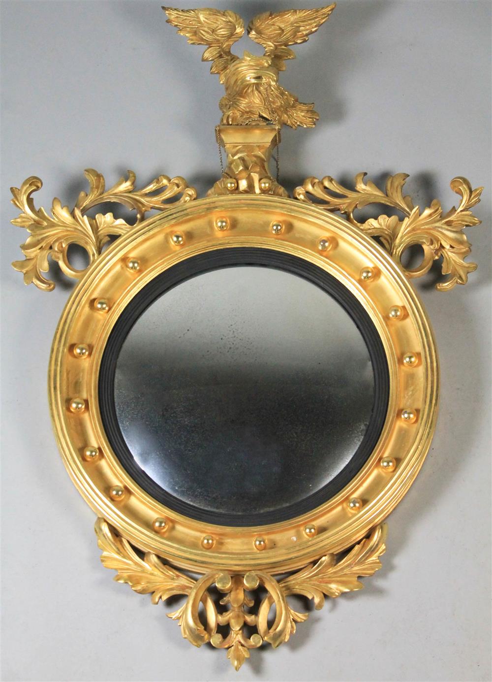 Appraisal: GILDED CONVEX MIRROR WITH EAGLE h w d in Provenance