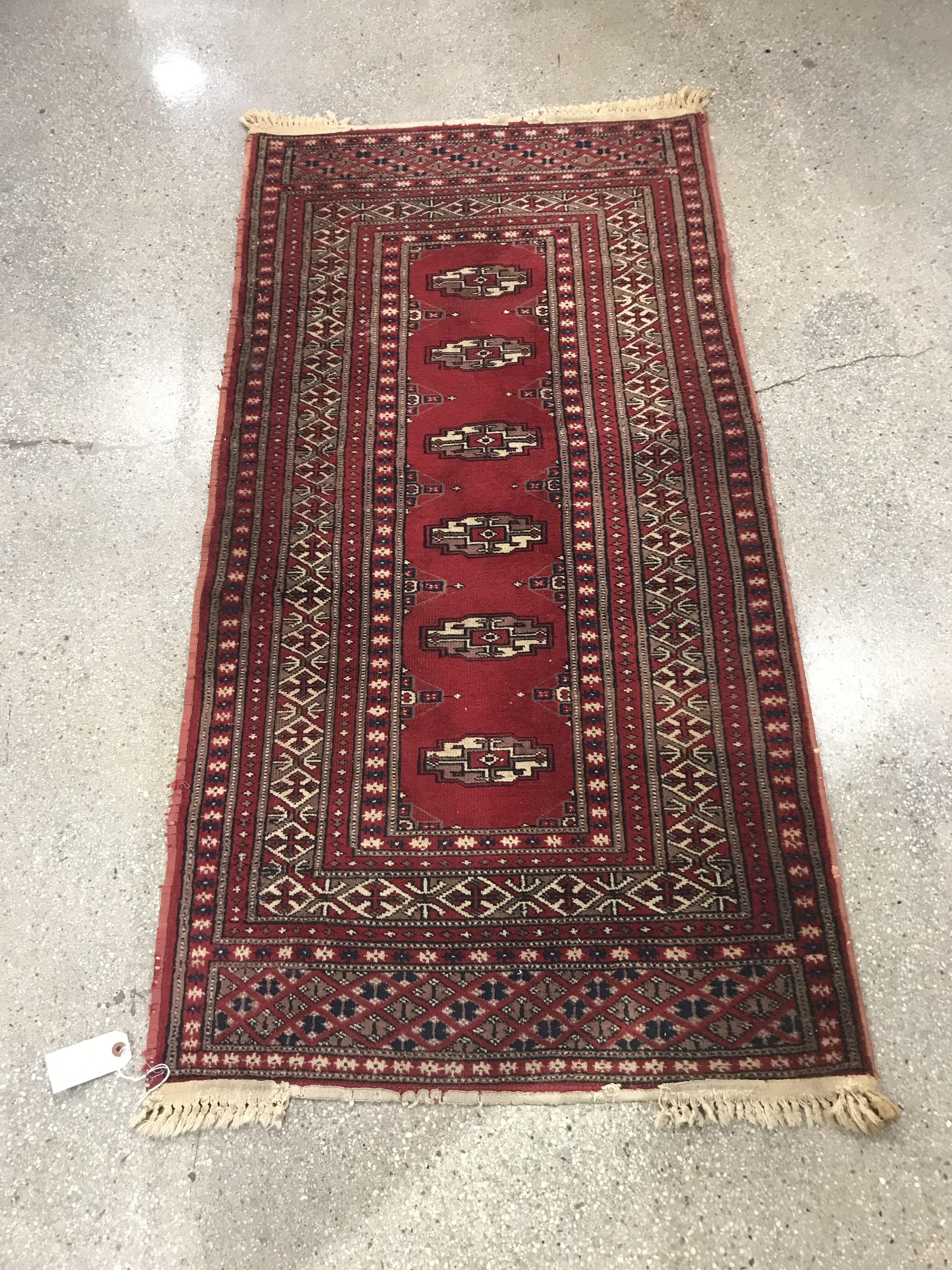 Appraisal: HAND-KNOTTED BOKHARA RUG Hand-knotted Bokhara wool rug with symmetrical geometric