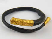 Appraisal: A black coral bangle with yellow metal tests high carat