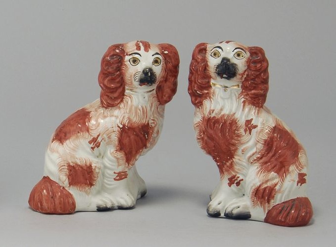 Appraisal: PAIR OF ENGLISH STAFFORDSHIRE POTTERY SPANIELS th CenturyIn red and