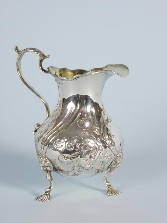 Appraisal: A Victorian Cream Jug with leafage scroll embossing and vacant