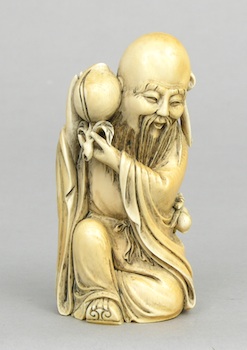 Appraisal: A Carved Ivory Man with Peach ca th Century Kneeling