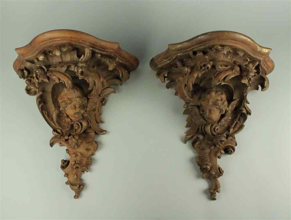 Appraisal: PAIR OF MAHOGANY CARVED BRACKETS with ogee cornice above vigorous