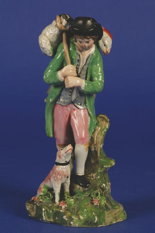 Appraisal: A WALTON TYPE STAFFORDSHIRE POTTERY FIGURE OF A SHEPHERD carrying