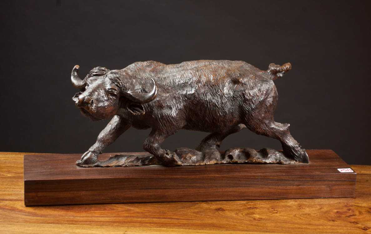 Appraisal: HAND CARVED WOOD WILDLIFE SCULPTURE an African Cape buffalo in