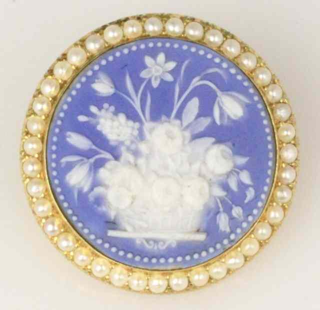 Appraisal: A jasperware brooch the circular panel decorated a basket of