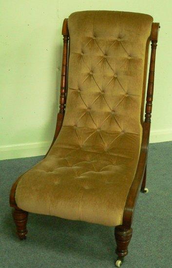 Appraisal: A Victorian upholstered low seat chair with deep buttoned back