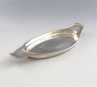 Appraisal: By Kenneth Lessons an oval butter dish with fluted handles