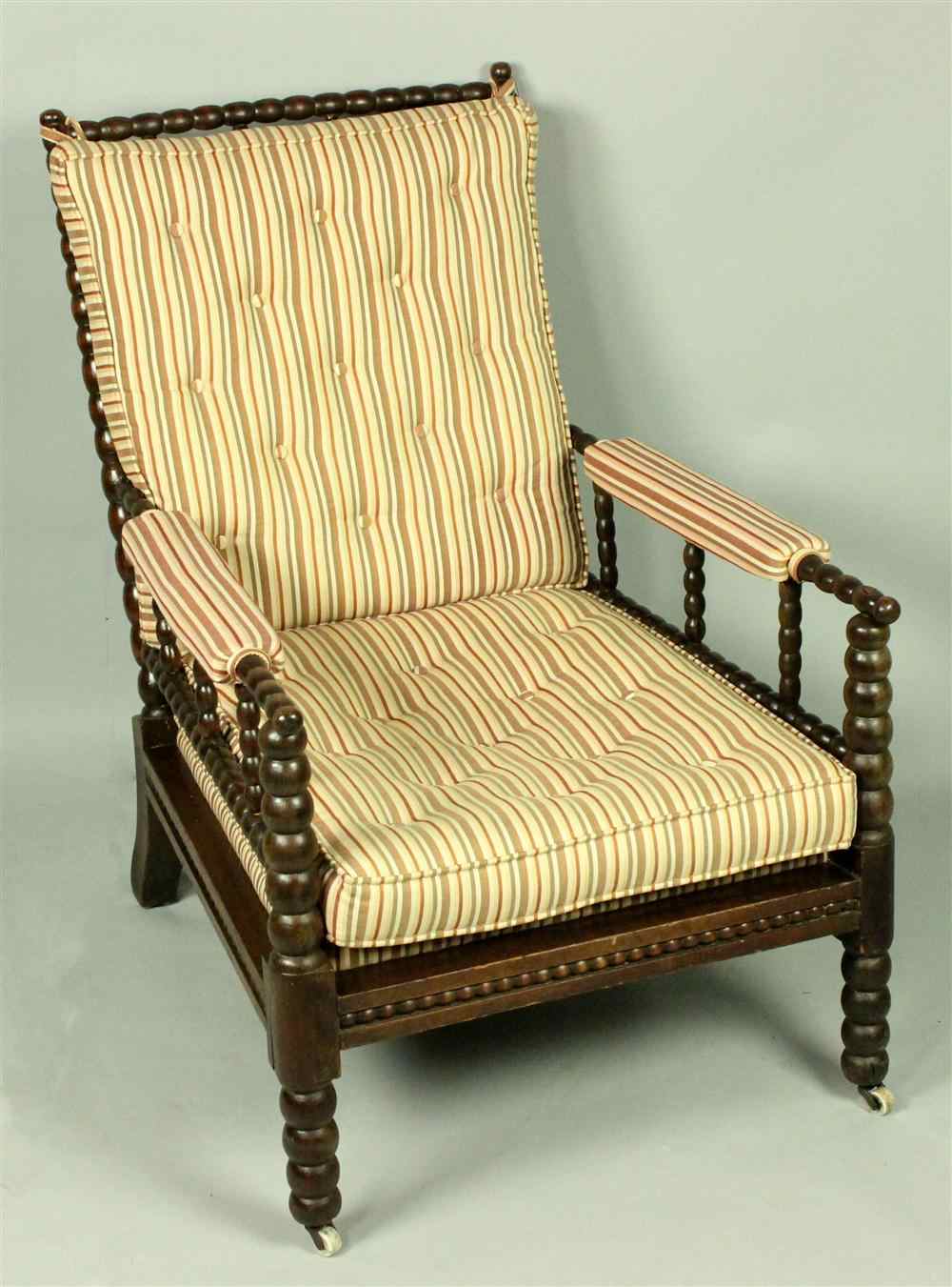 Appraisal: VICTORIAN SPOOL CARVED ARMCHAIR WITH STRIPED UPHOLSTERY having a straight